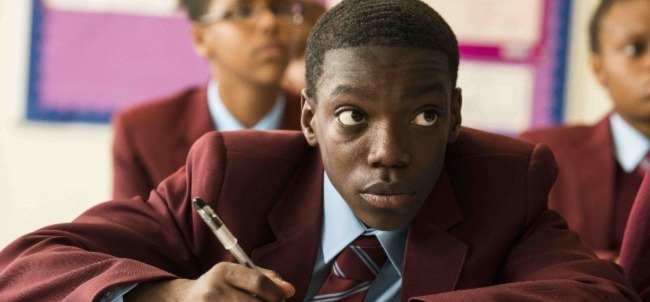 a young male student concentrates in the classroom